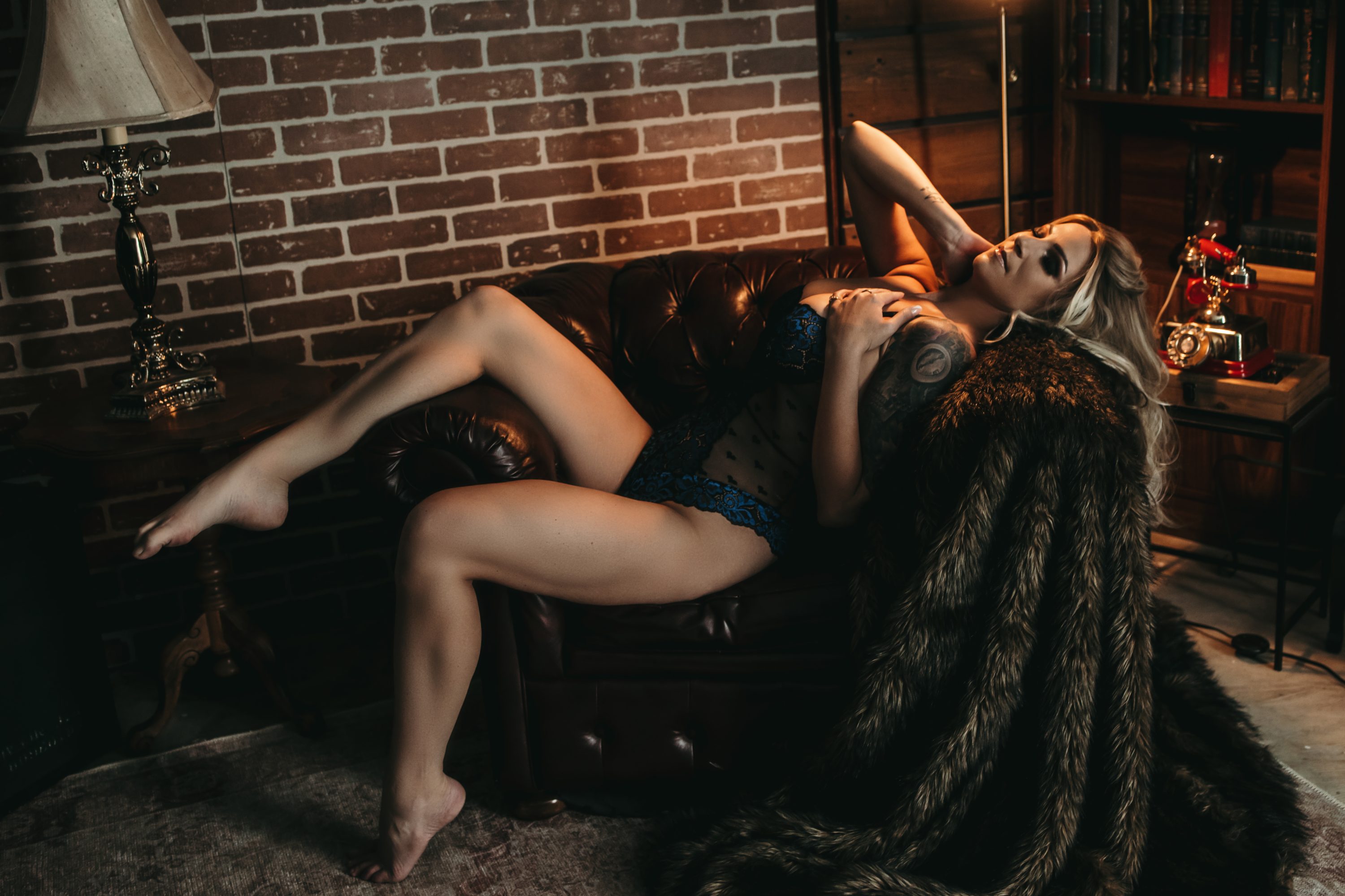 Posing for a hot and steamy boudoir shoot at Gabriela Cruz studios.